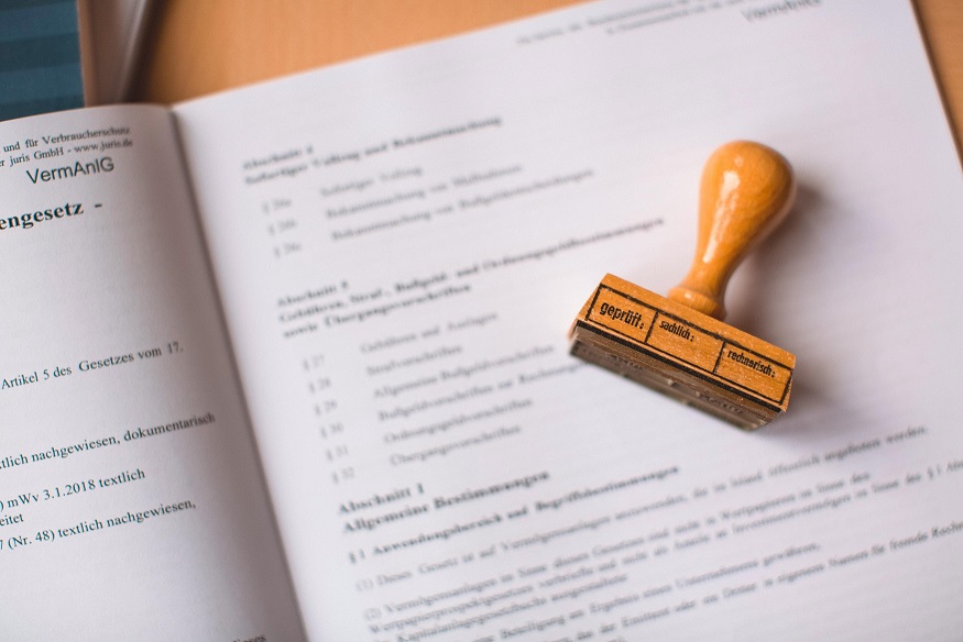 papers on desk with stamp on top